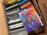 a cardboard box full of dvds and other movies