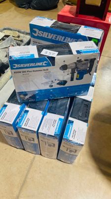 a pile of boxes on the floor next to a red chair