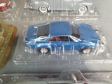 three toy cars in a plastic case on a table