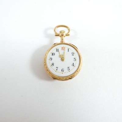 a gold pocket watch with a white face on a white surface
