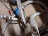 a hose connected to a water heater on the floor