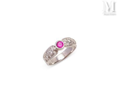 a close up of a ring with a pink stone on it