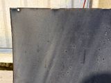 a black sign that is on the side of a building