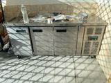 an image of a commercial kitchen with a stainless steel counter top