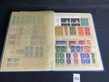 an open book with stamps on it on a table