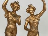 pair of antique bronze figurines of women holding a basket