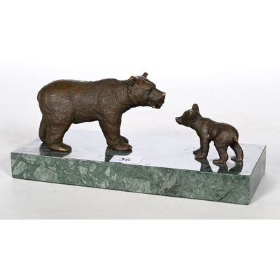 statue of a mother bear and her cub on a marble base