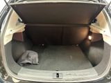 the back of a car with the trunk open and a blanket in the trunk