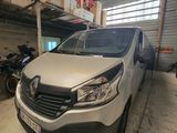 La camionnette blanche est garée dans le garage, à côté des motos.