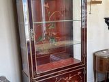 a cabinet with a glass door that has a floral design on it