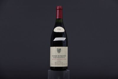 a bottle of wine sitting on top of a black table