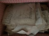 a box full of old papers and papers on the floor