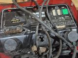 a red and black engine and some wires in a box