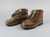 pair of brown leather boots with zippers on them on a white surface