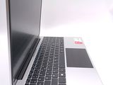 a silver laptop with a black keyboard on a white surface