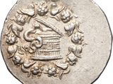 a close up of a silver coin with a birdcage on it