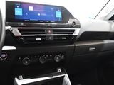 the interior of a car with a steering wheel and dashboard controls