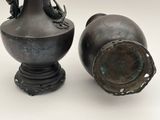two vases sitting next to each other on a table