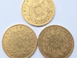 three gold sovereigns, one of which is a sovereign and one of which is a sovereign
