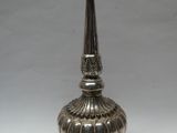 an image of a silver vase sitting on top of a white table