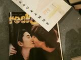 a book with a picture of a man kissing a woman on the cover of a magazine