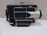 a black and silver camera sitting on a white table