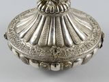 an ornate silver box with a bird on top of it