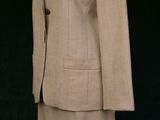 an image of a woman ' s dress and jacket on a mannequin