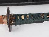 a close up of a knife on a white surface