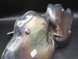 a close up of a metal object on a black surface