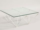 a glass coffee table with a metal frame and a glass top
