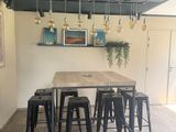 a table with six stools in the middle of the room