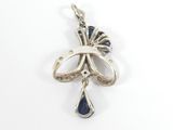 a close up of a silver and blue pendant on a white background