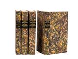 two books sitting on top of each other on a white surface