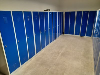 several blue lockers are lined up in a row in a room