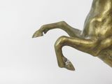 bronze statue of a horse rearing up on its hind legs