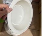 a person that is holding a white bowl in their hand