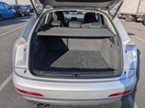 the back of a car with its trunk open in a parking lot