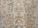 an antique persian rug with a floral design on a blue ground