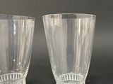 pair of clear glass vases sitting on top of a black table