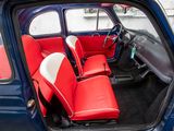the interior of a small car with red and white seats