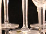 many empty wine glasses lined up on a table
