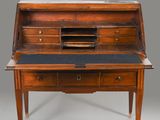 an old wooden desk with a black top and drawers