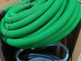 a box full of green and blue hoses in it