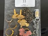 a bag of assorted jewelry sitting on a table