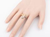a close up of a person ' s hand with a ring on it