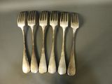 four forks that are sitting on a table