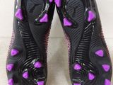 purple and black soccer cleats with hearts on them on a white surface