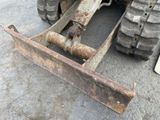 a close up of the front end of a tractor with a plow attachment