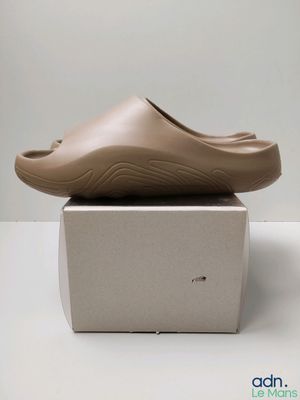 the shoe is sitting on top of the box on the table